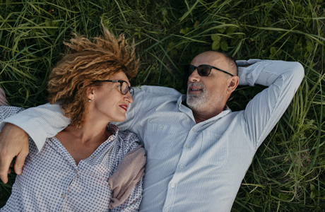 Couple laying on grass